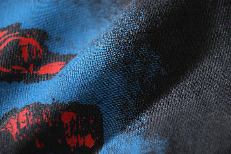 Black T-shirt fabric close-up with blue and red print