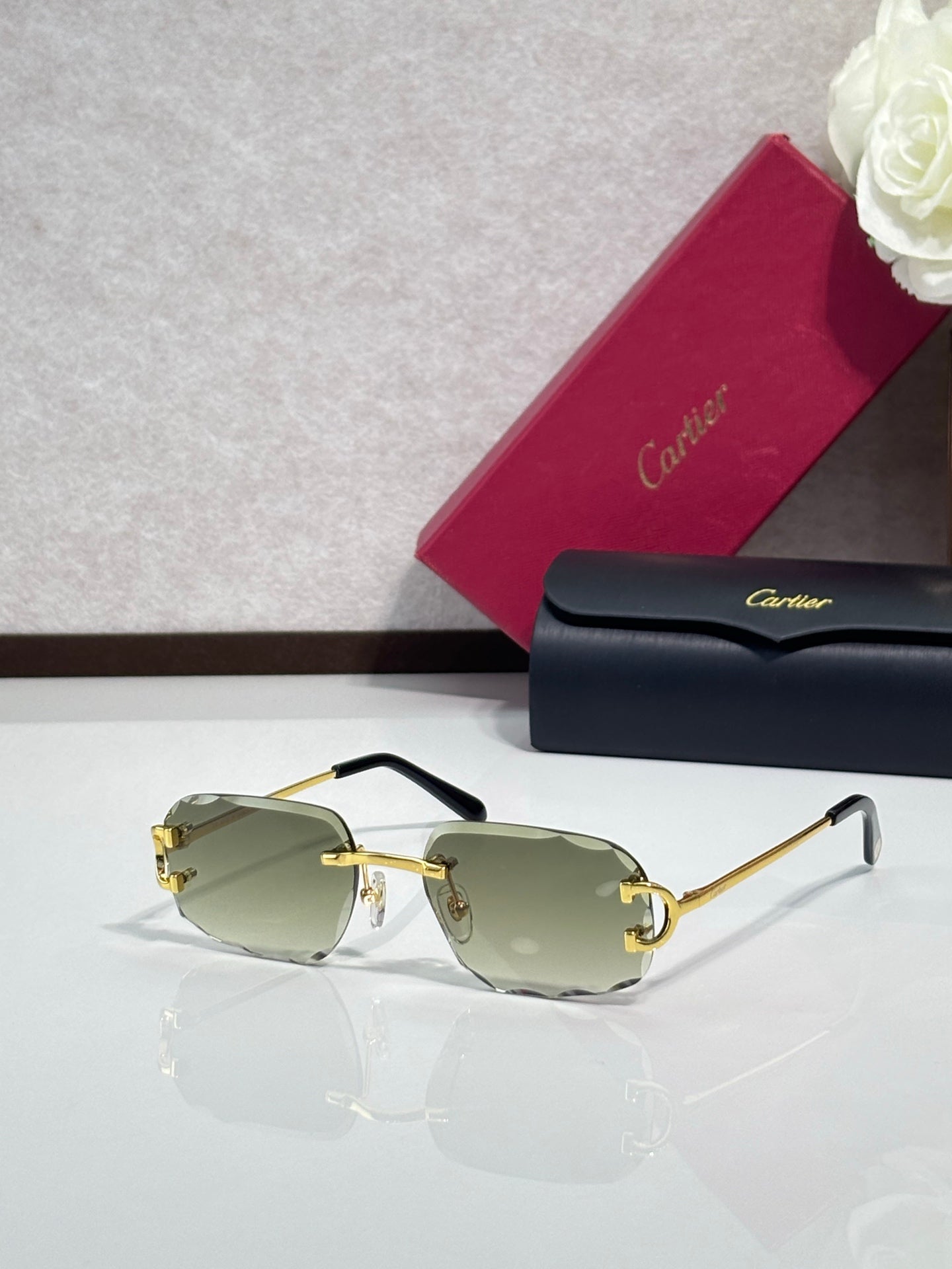 Cartier eyeglasses with green-tinted lenses, gold frame, black arms