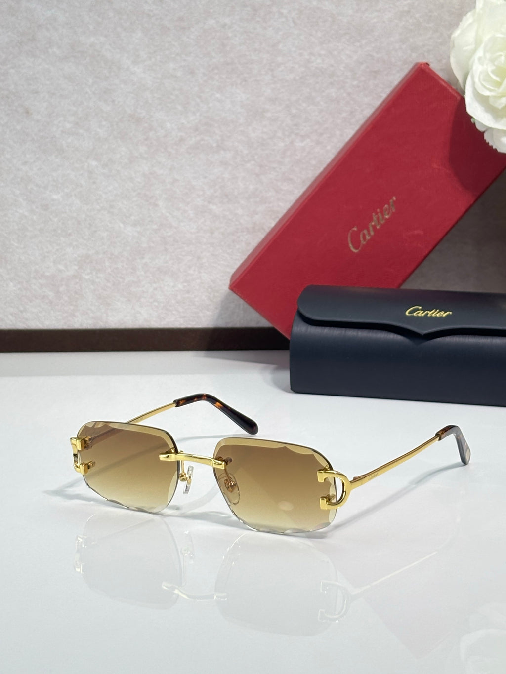 Cartier eyeglasses with gold-tinted lenses, gold frame, black arms
