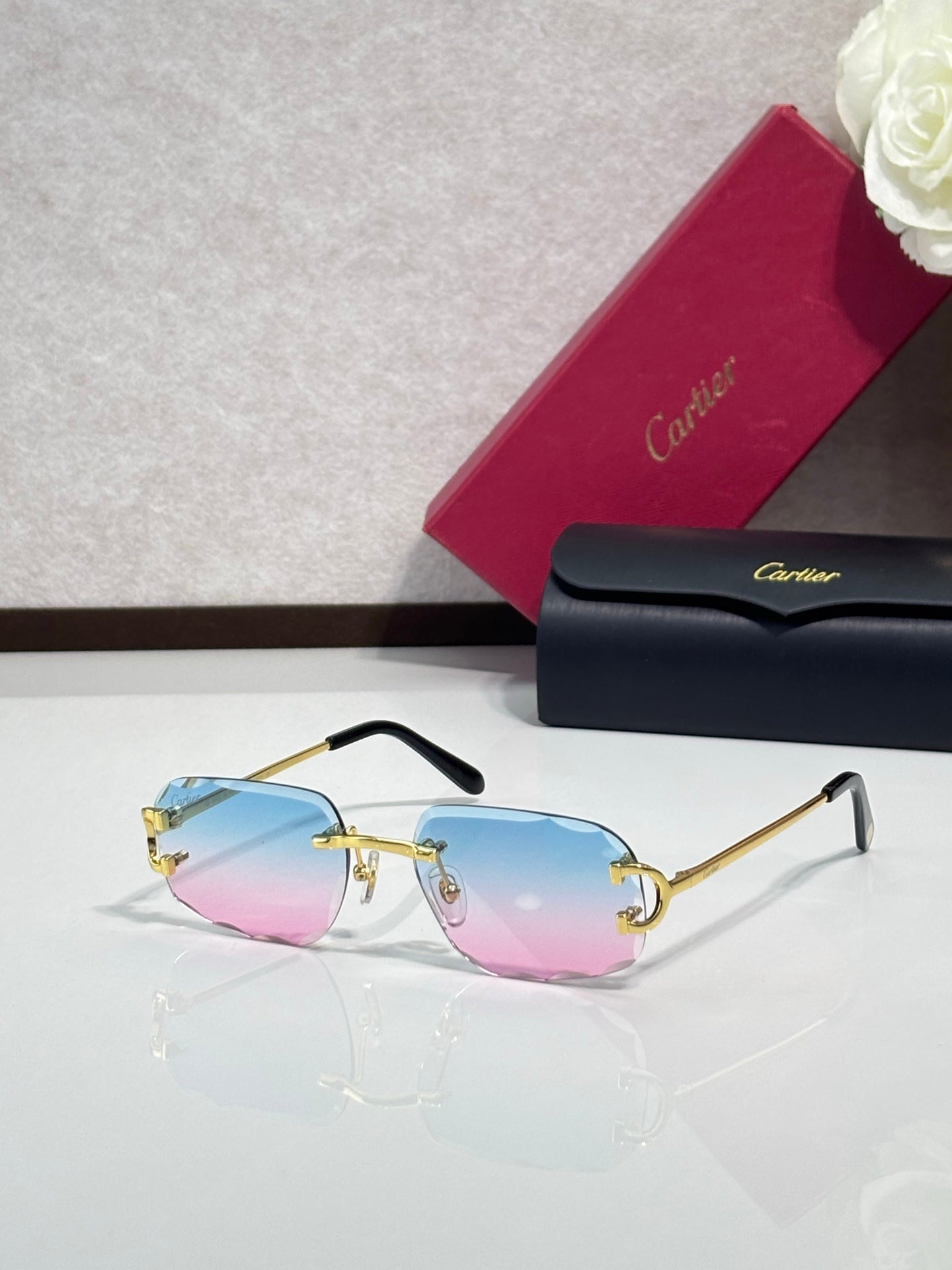 Cartier eyeglasses with blue-to-pink gradient lenses, gold frame, black arms