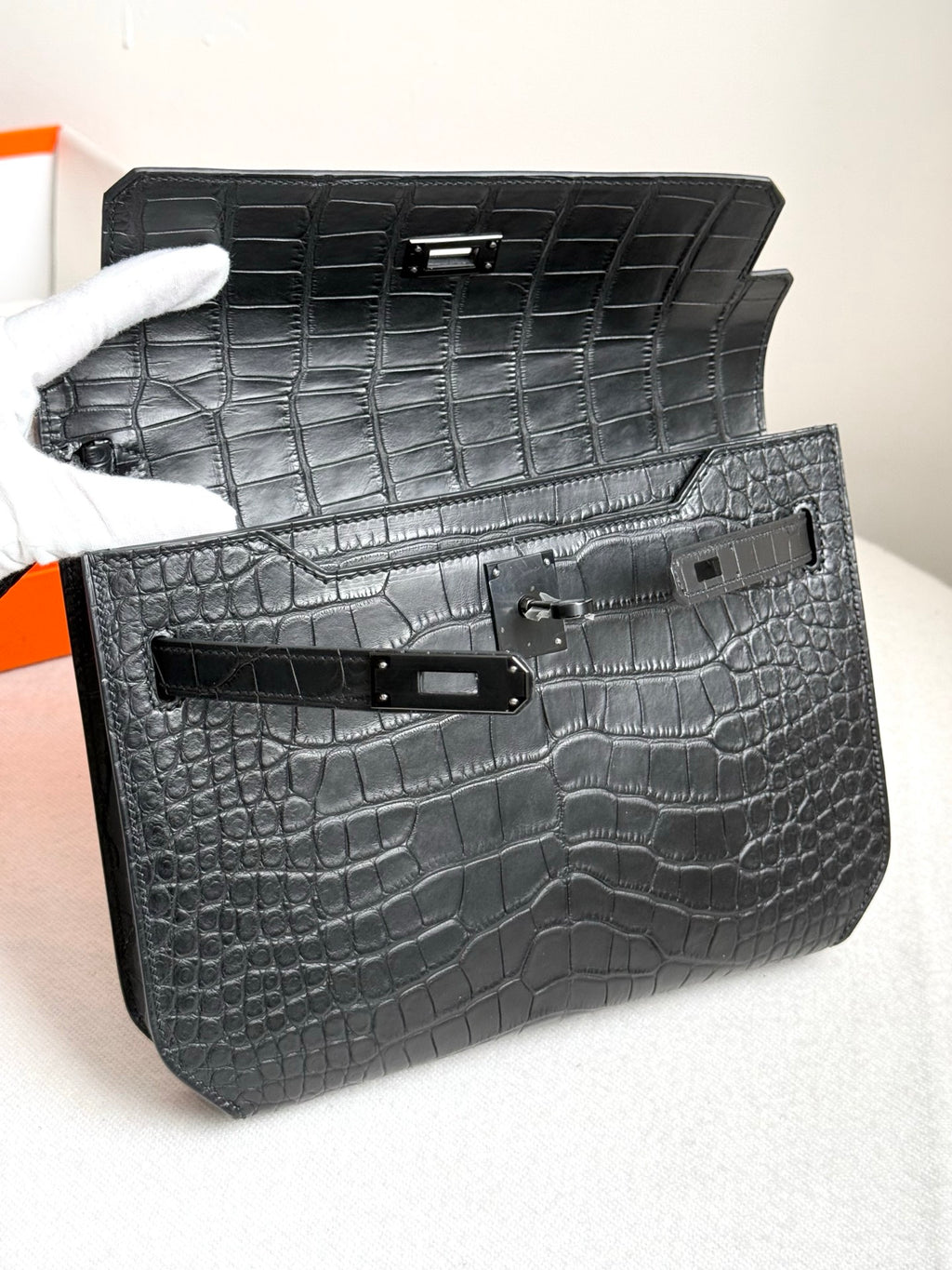 Hermes bag open showing dark croc-embossed interior and front flap hardware