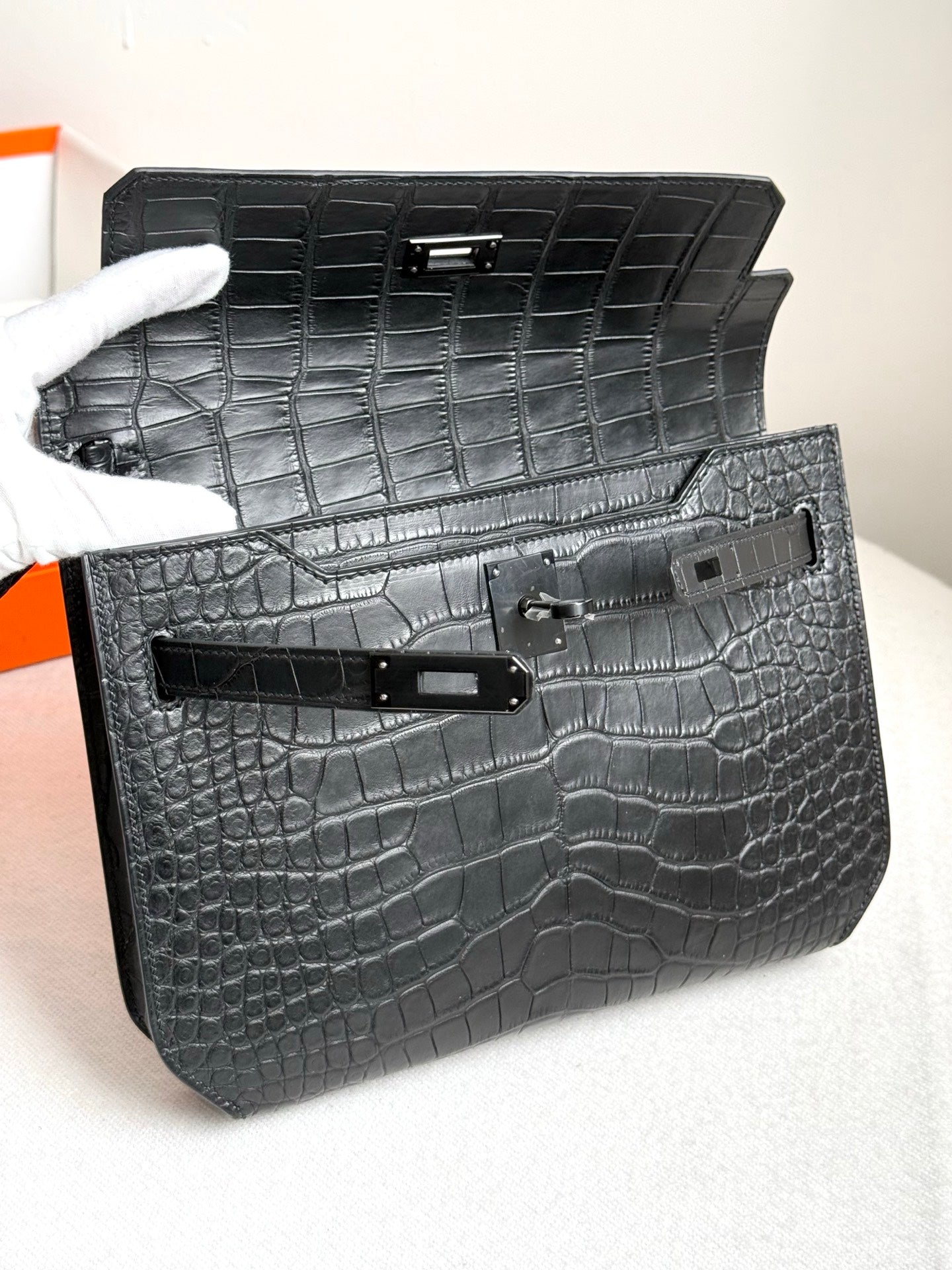 Hermes bag open showing dark croc-embossed interior and front flap hardware