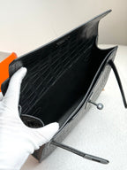 Hermes bag open interior view with dark croc-embossed lining and side strap hardware