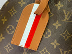 Striped leather luggage tag on monogram bag in red and white