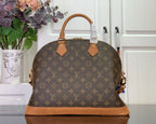 Louis Vuitton monogram duffel bag with tan top handles and brown leather tabs