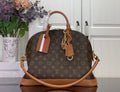 Louis Vuitton monogram duffel bag with tan leather handles and striped luggage tag
