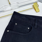 Versace dark blue jeans close-up of front pocket with metal rivets and stitching