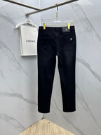 Versace dark blue denim jeans on a hanger, front view with button and pockets