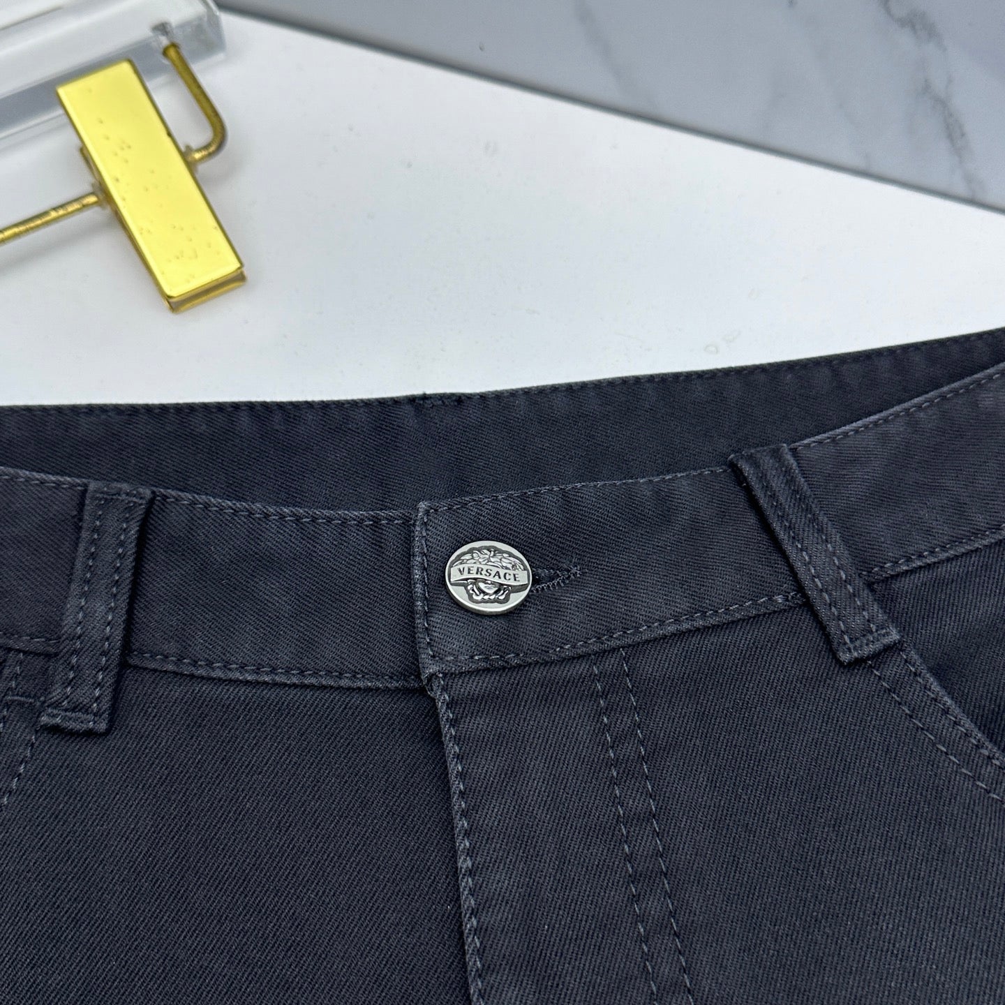 Versace dark blue jeans close-up of waistband with inner label and belt loops