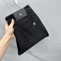 Versace dark blue denim jeans, folded view with leather logo patch at waistband