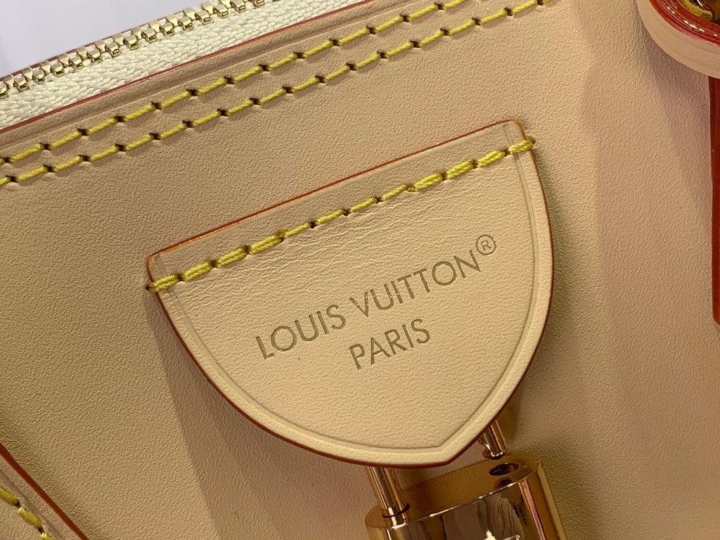 Beige interior leather patch with gold stitching and stamped 'LOUIS VUITTON PARIS'