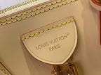 Beige interior leather patch with gold stitching and stamped 'LOUIS VUITTON PARIS'