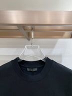 Navy T-shirt neckline close-up with brand label at inner collar