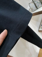 Dark navy T-shirt sleeve close-up showing seam and fabric texture