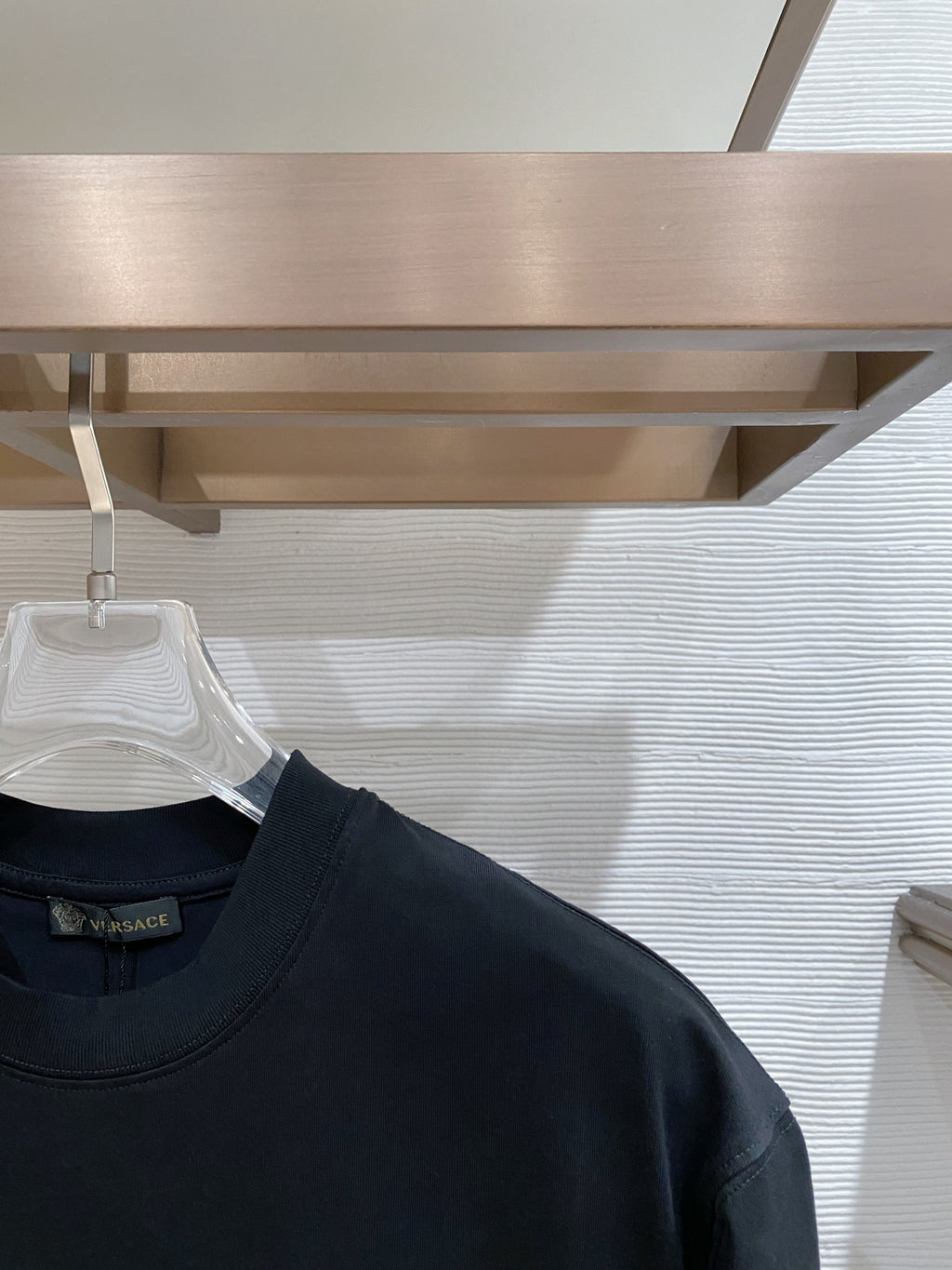 Dark navy T-shirt shoulder and neckline with short sleeves on hanger