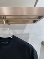 Dark navy T-shirt shoulder and neckline with short sleeves on hanger