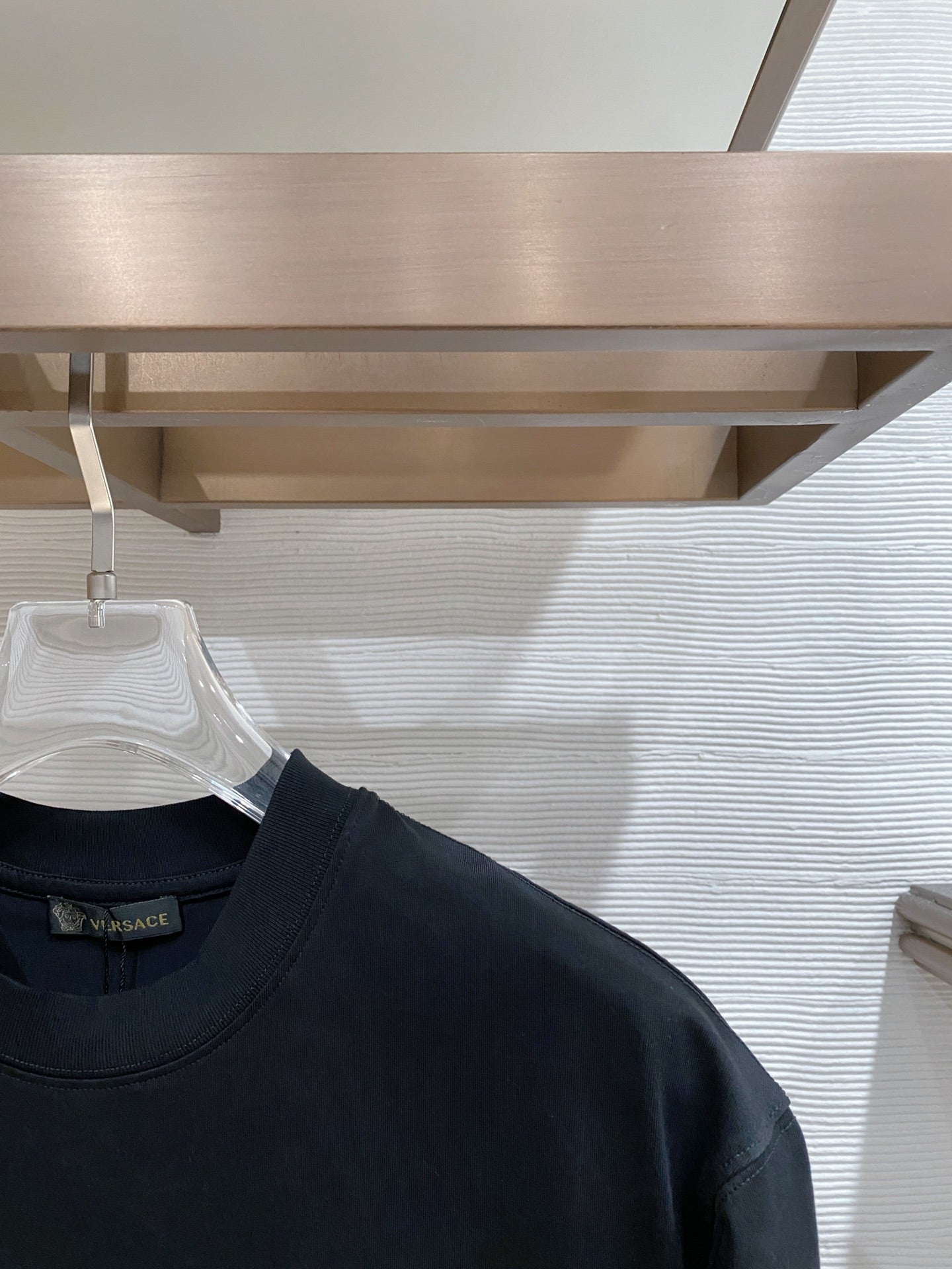 Dark navy T-shirt shoulder and neckline with short sleeves on hanger