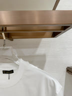 Versace T-shirt with crew neck, short sleeves, and neck label on white fabric.