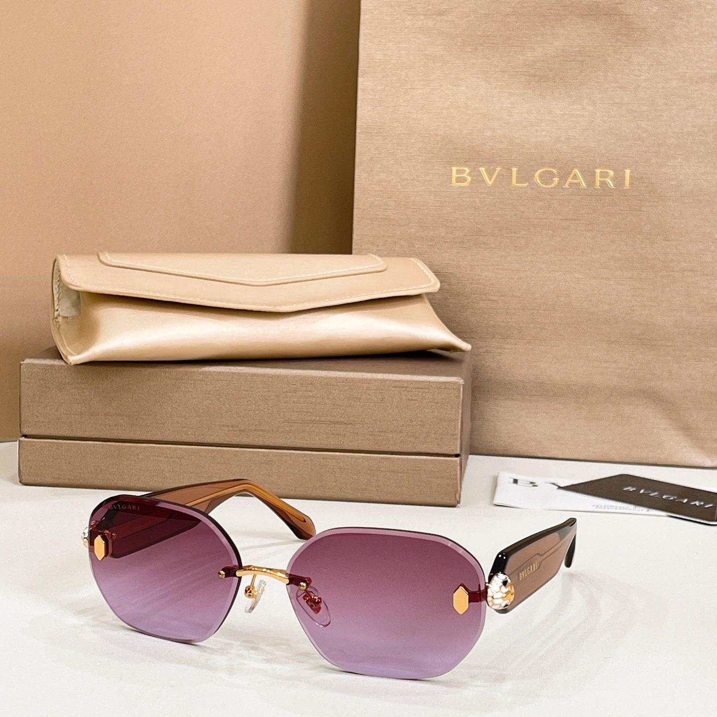 Bvlgari sunglasses with purple lenses and gold-tone frame