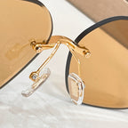 Round sunglasses side view with gold-tone frame and clear temple tips