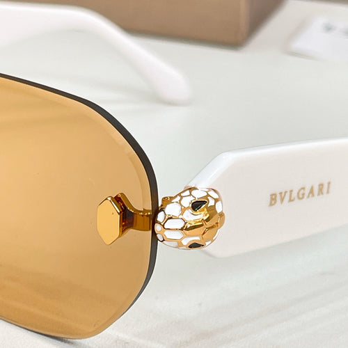 Round sunglasses close-up with gold-tone frame and amber lenses