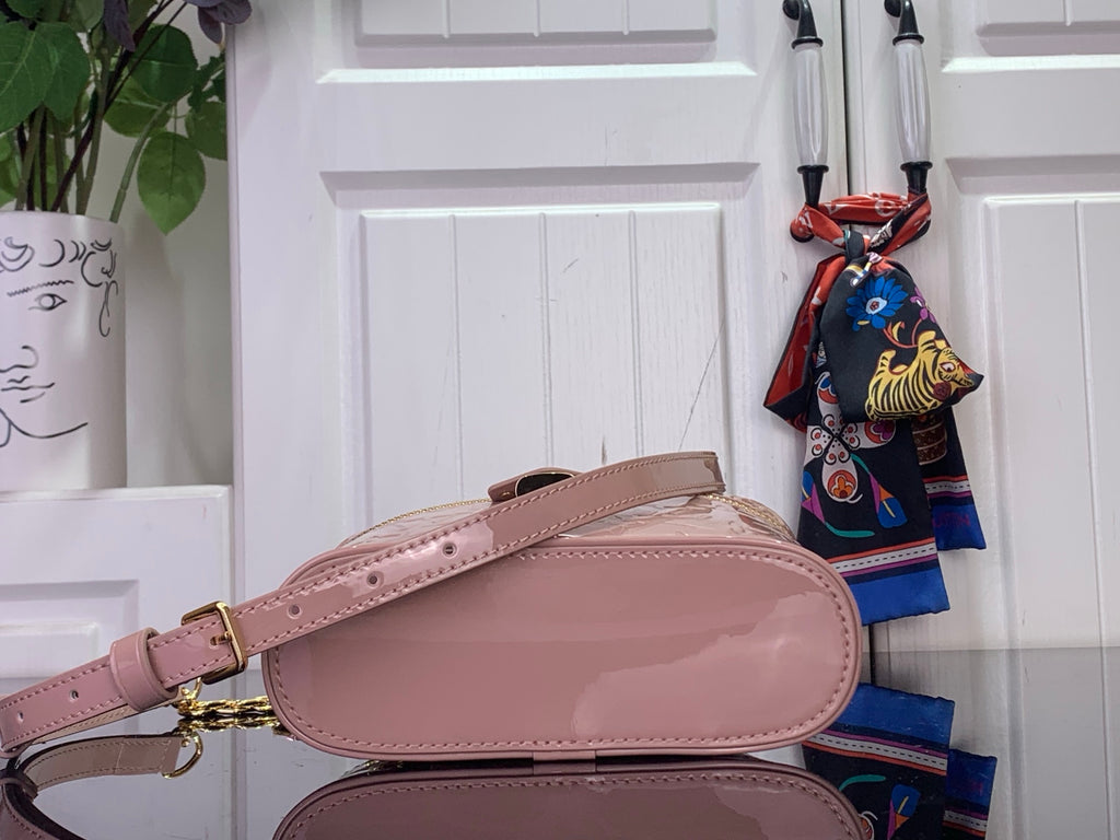 Louis Vuitton crossbody bag in mauve pink with adjustable strap and gold chain accents