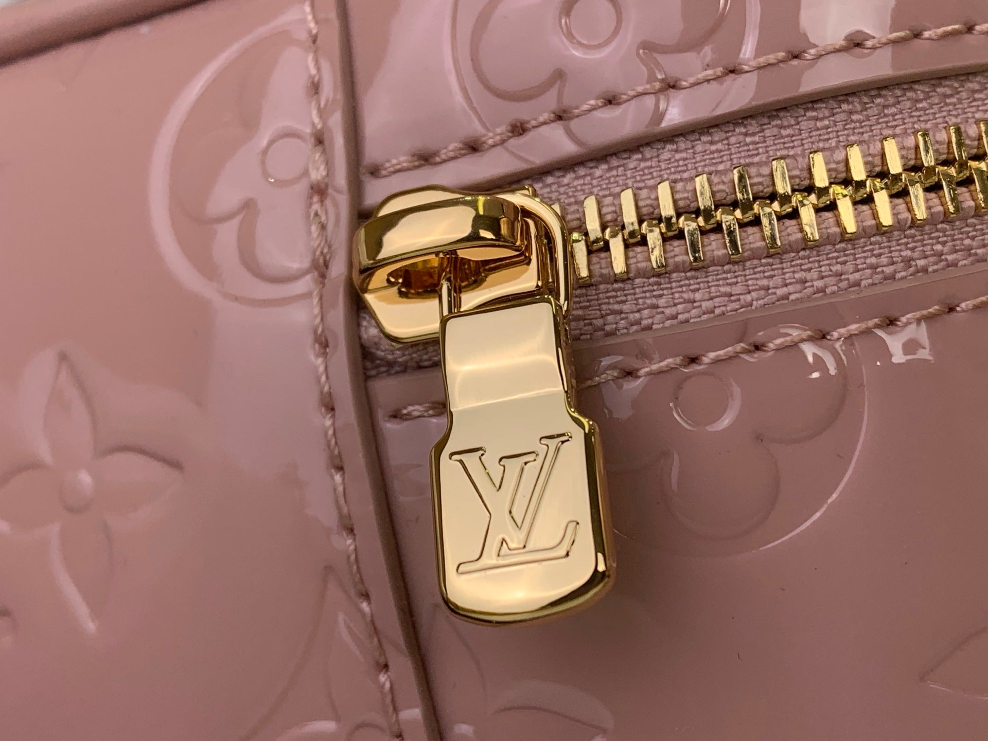 Louis Vuitton handbag top clasp with gold hardware on mauve embossed monogram leather