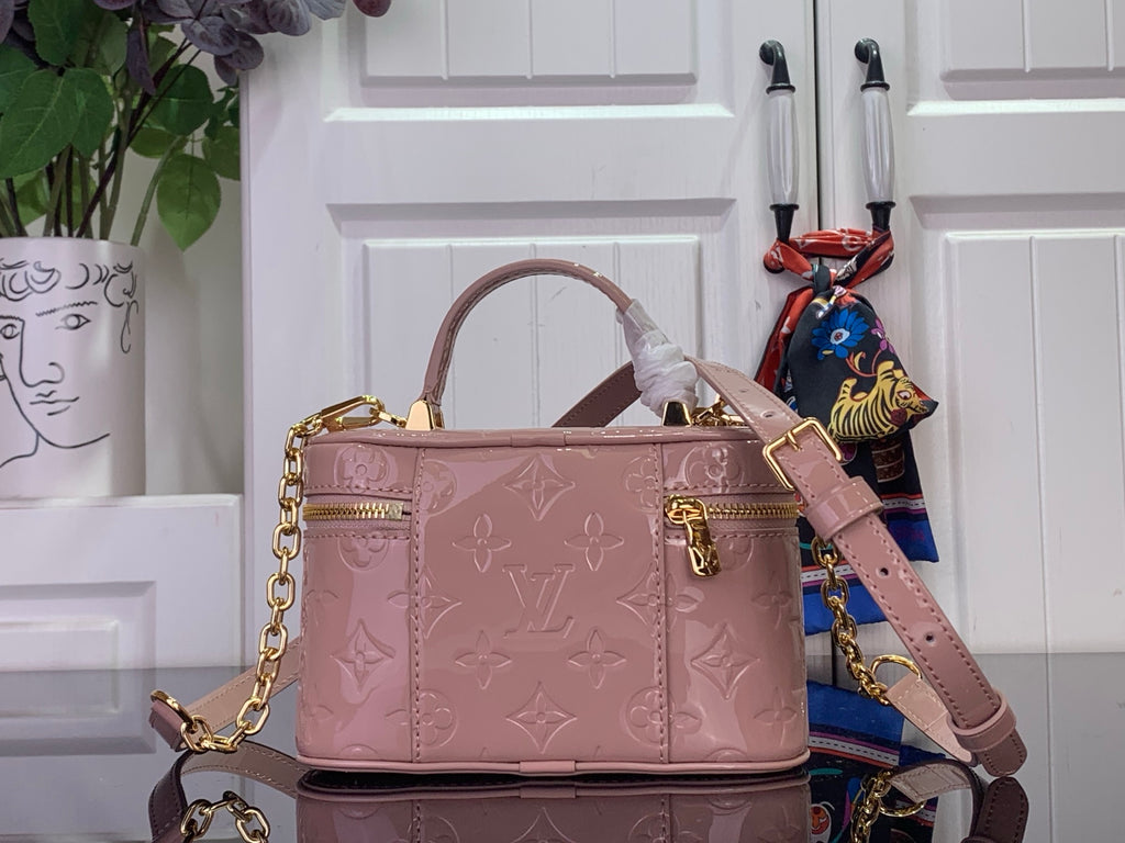 Louis Vuitton handbag in mauve pink with gold clasp, embossed monogram, and shoulder strap