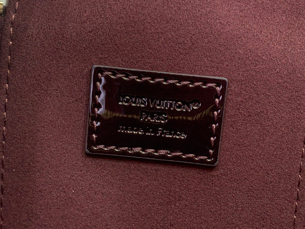 Louis Vuitton Paris logo patch on maroon leather interior pocket