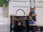 Louis Vuitton patent monogram handbag with blue gem charm and gold chain strap