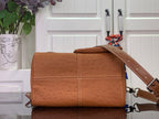 Tan leather handbag with folded flap top, stitched panel design, and crossbody strap