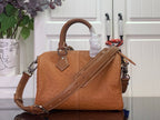 Tan leather Louis Vuitton tote with top handle, long shoulder strap and stitched front panels.