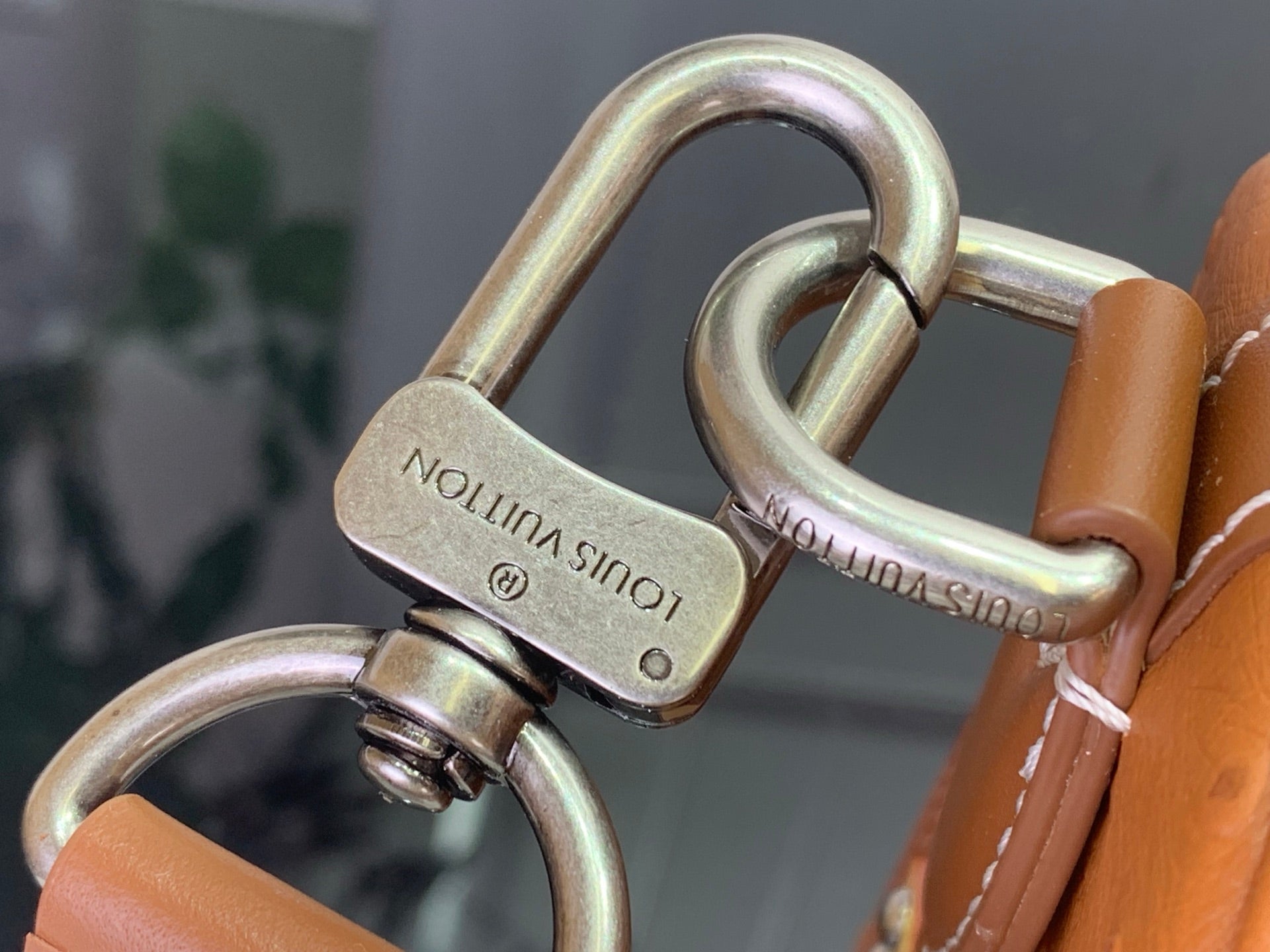 Louis Vuitton bag handle with tan leather and gold-tone metal rings