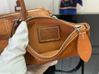 Tan Louis Vuitton mini bag interior label with zip edge and engraved logo plaque.