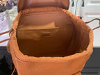 Cognac leather backpack interior lining with top opening and hanging pocket.