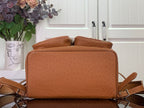 Cognac brown leather backpack base with flat zip top and shoulder straps attached.