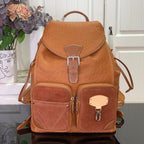 Cognac brown leather backpack with front flap, buckle strap and two front pockets.