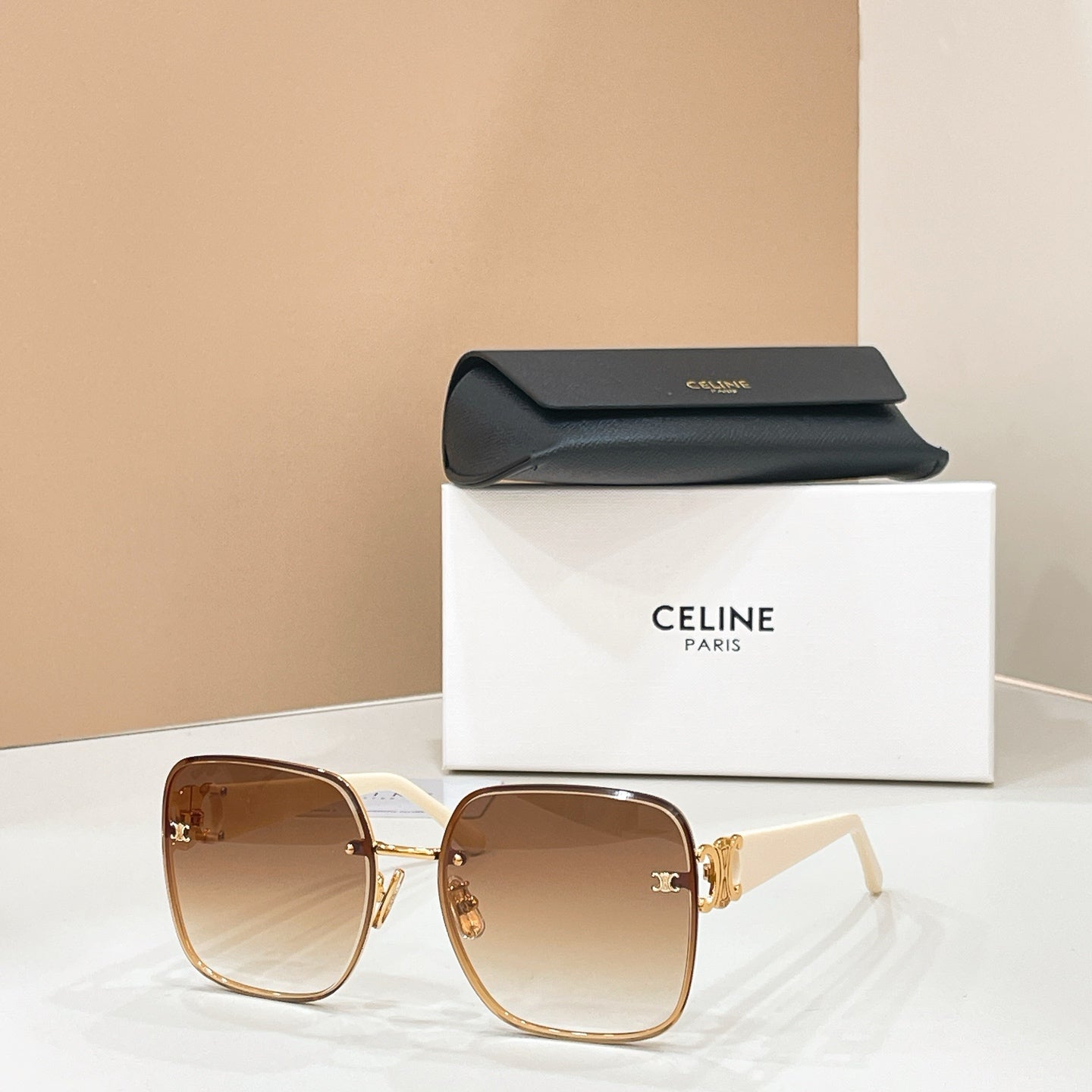 Celine sunglasses with brown lenses and tan frame, gold logo detail