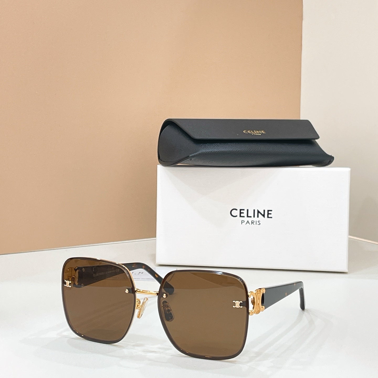 Celine sunglasses with dark brown lenses and gold-trimmed frame, logo detail