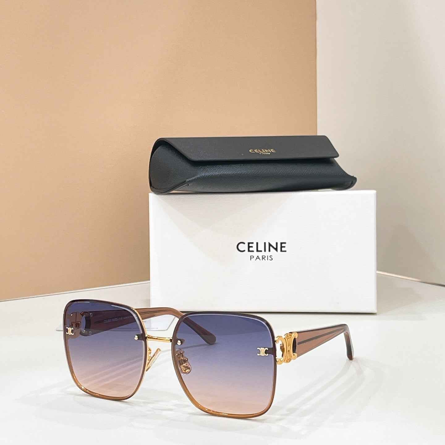 Celine sunglasses with purple gradient lenses and rose-tan frame, gold logo