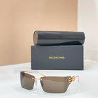Sunglasses with gold-tone frame and brown-tinted lenses, geometric temple logo detail.