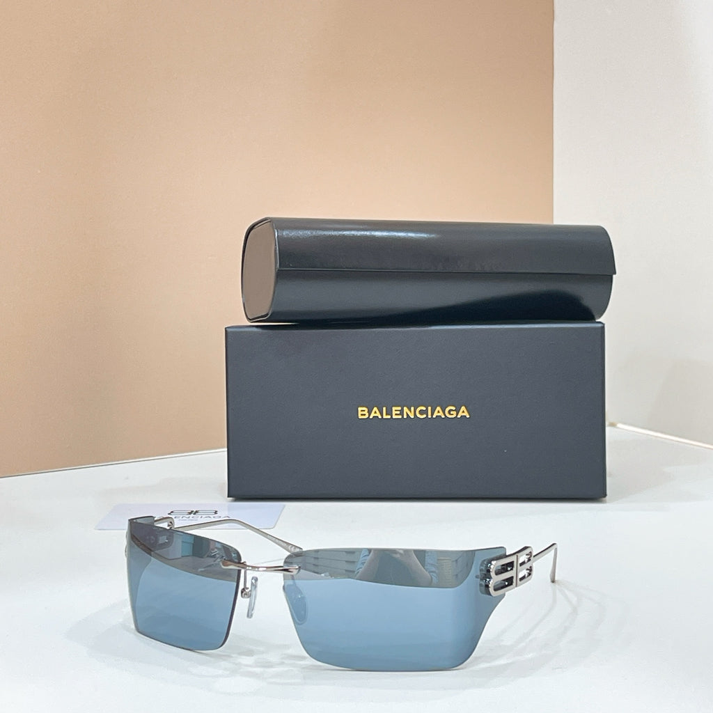 Sunglasses with gold-tone frame and blue-tinted lenses, geometric temple logo hardware.