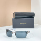 Sunglasses with gold-tone frame and blue-tinted lenses, geometric temple logo hardware.