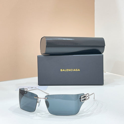Sunglasses with gold-tone frame and blue-tinted lenses, geometric temple logo hardware.