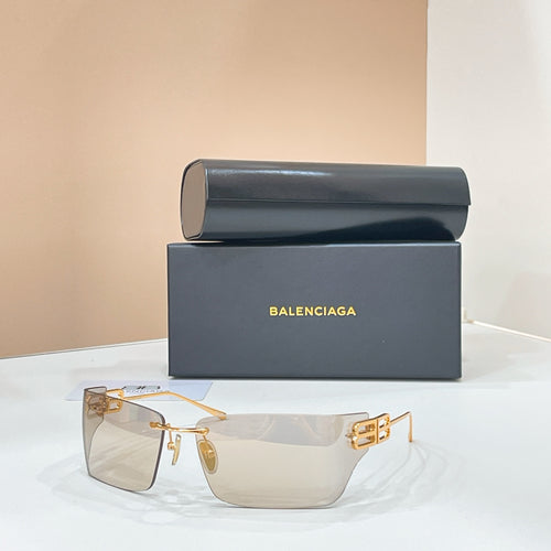 Sunglasses with gold-tone frame, clear lenses, and geometric logo detail at temples.