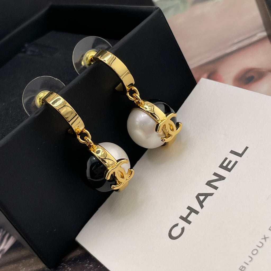 Chanel earrings with gold-tone hoop backs and black-and-white dangling round charms