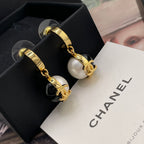 Chanel earrings with gold-tone hoop backs and black-and-white dangling round charms