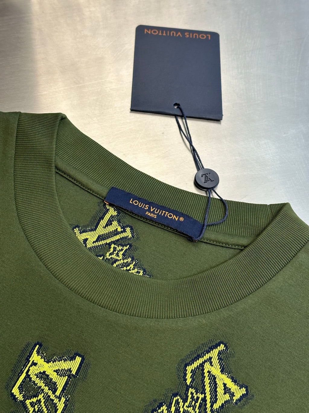 Green crewneck shirt with Louis Vuitton label at collar and yellow embroidered logos