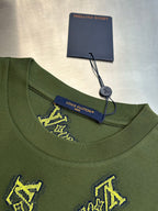 Green crewneck shirt with Louis Vuitton label at collar and yellow embroidered logos
