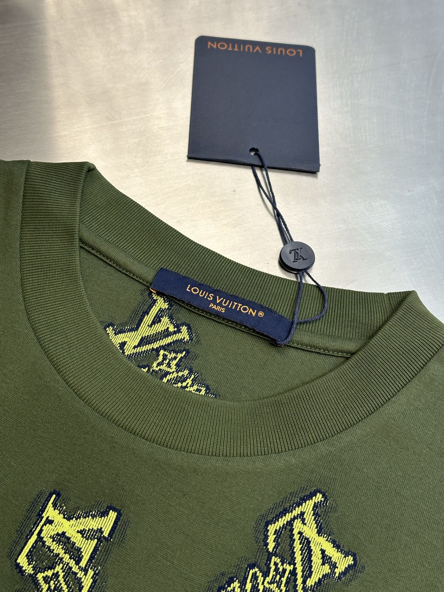 Green crewneck shirt with Louis Vuitton label at collar and yellow embroidered logos